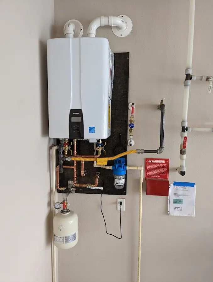 Professional plumber installing copper piping in a Southside home